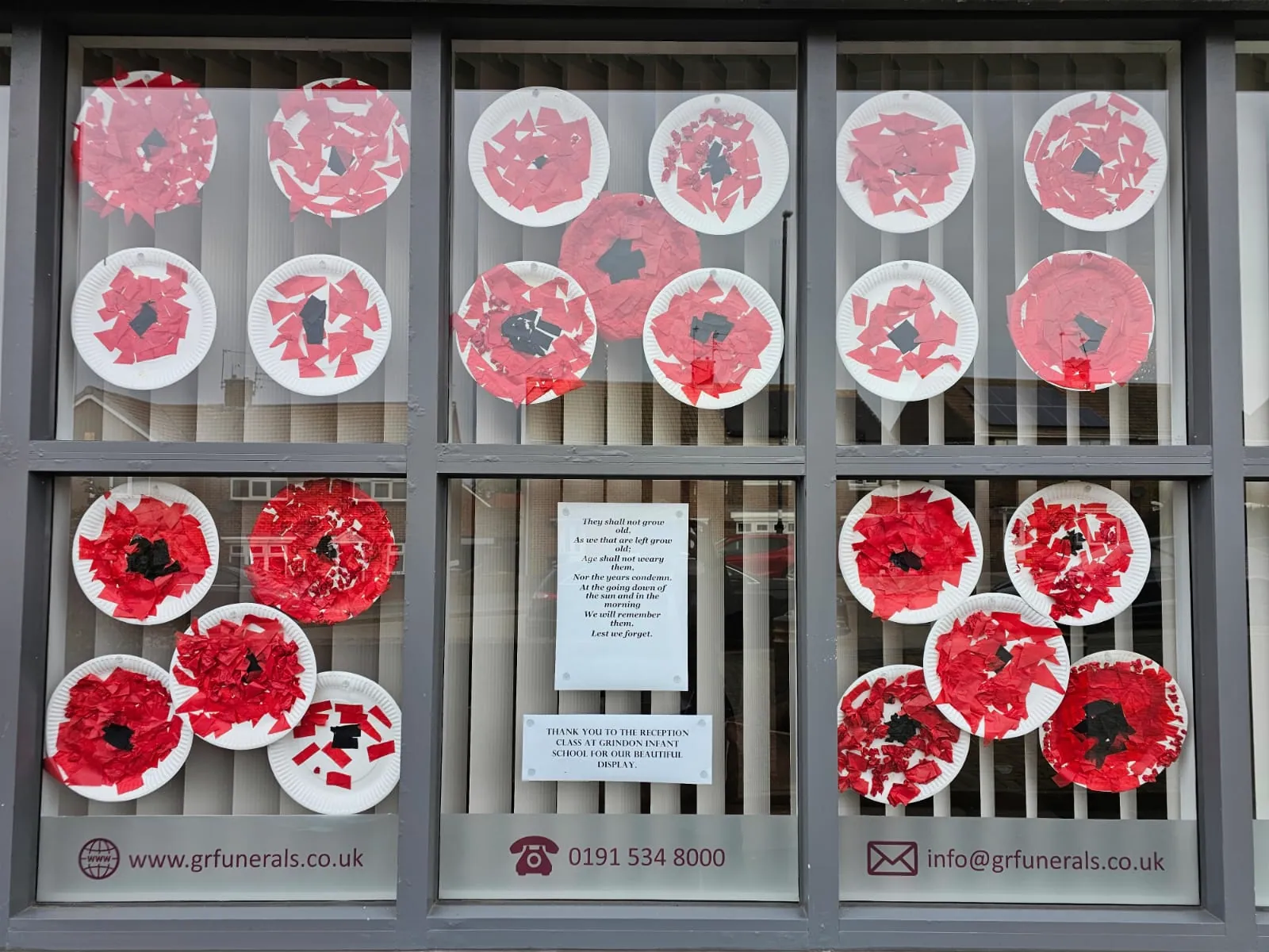 Paper poppies in the Grindon window, made by the reception class at Grindon Infant School